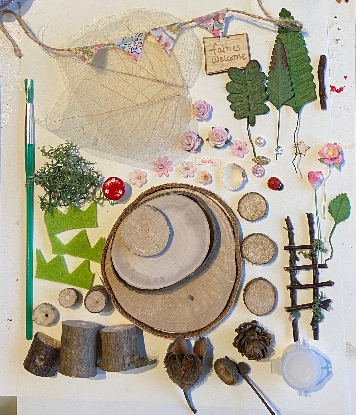 DIY fairy tree house with table, step ladder and tiny liberty print bunting