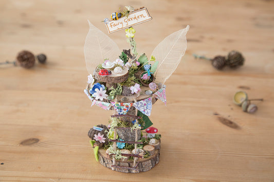 DIY fairy tree house with table, step ladder and tiny liberty print bunting