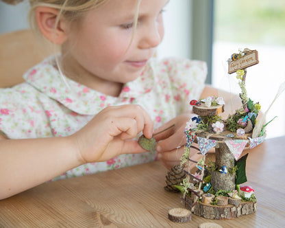 DIY fairy tree house with table, step ladder and tiny liberty print bunting