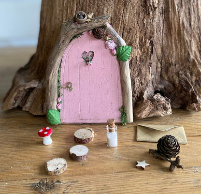 Foraged wood fairy door with stepping stones, magic fairy dust and toadstool.